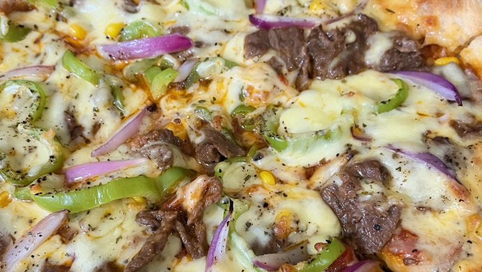 Traditional Italian beef pizza with black peppers